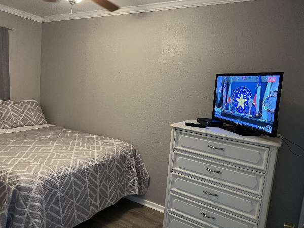 Bedroom With Queen Size Bed And A 32 inch TV 